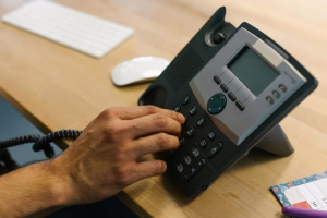 person using business phone - Fireline Broadband voip vs landlines