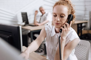 woman using business phone - Fireline Broadband voip calls