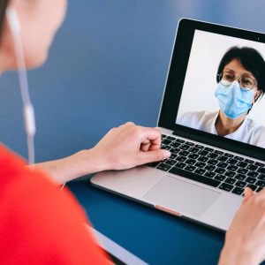 How UC Improves Remote Work Productivity | Fireline Communications person using business phone - Fireline Broadband phone security hosted voip unified communications remote work
