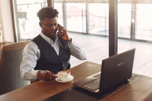 Fireline Communications AI Voice Agents - man talking on the phone while on the laptop
